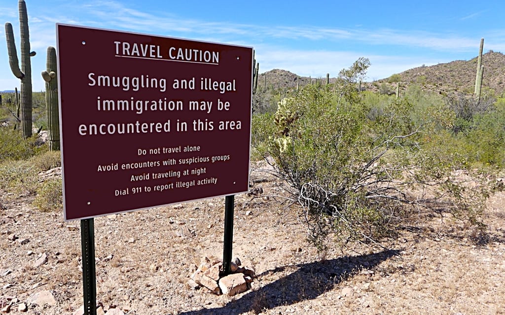 border sign: smuggling and illegal immigration may be encountered in this area